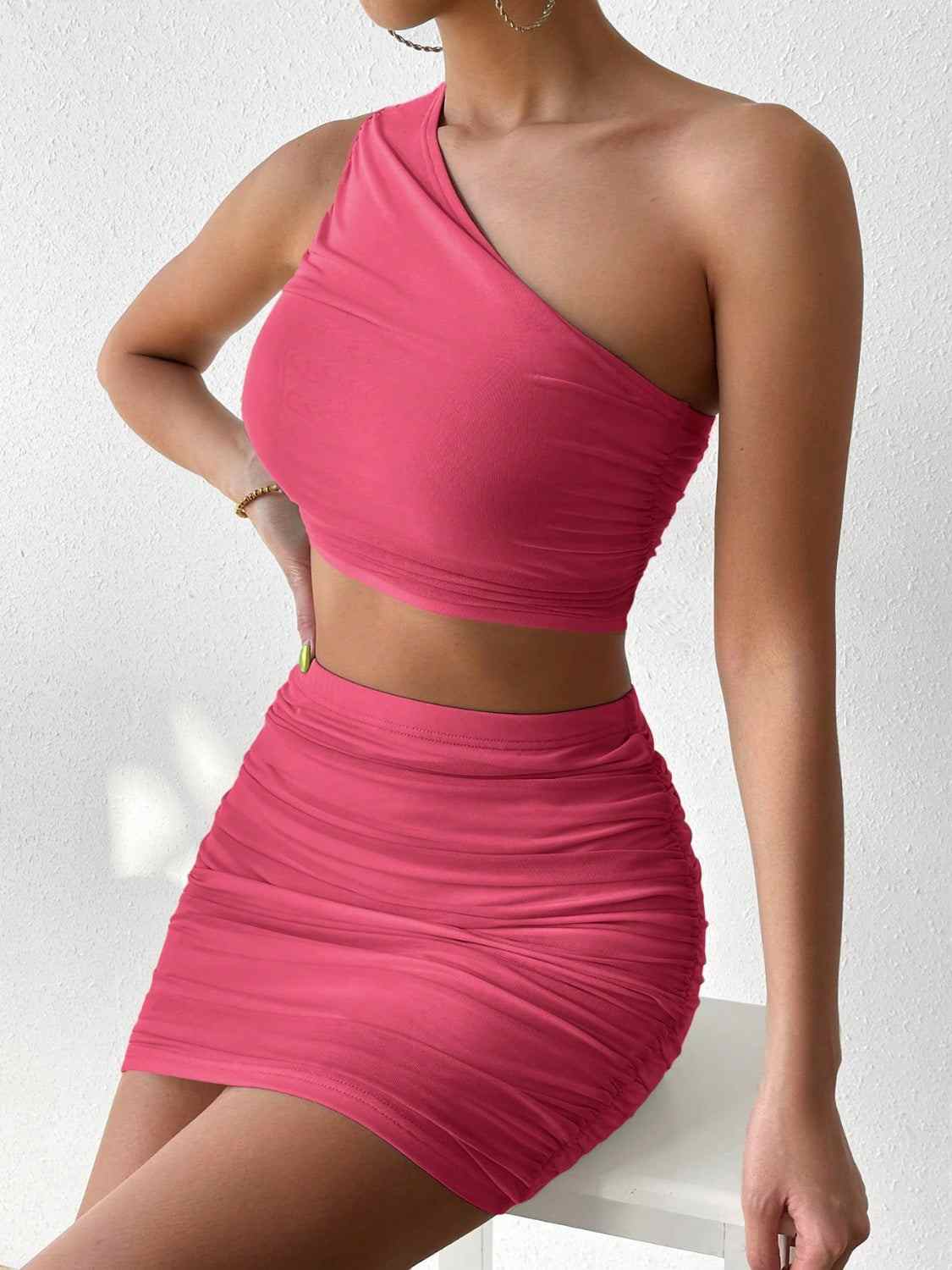 Ruched single shoulder top and skirt set in pink, featuring a highly stretchy, bodycon design.