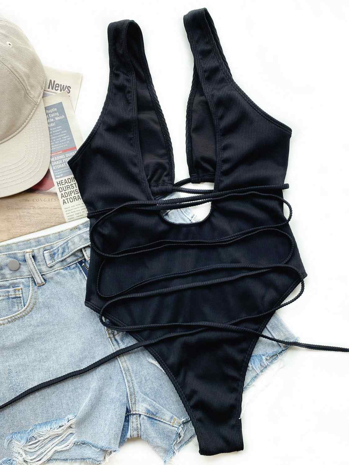 Ribbed lace-up one-piece swimsuit with removable padding, no underwire, and stretchy material.