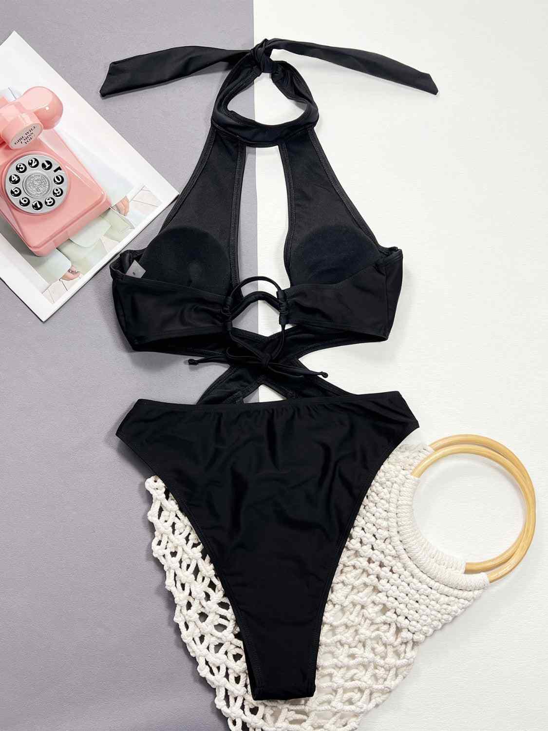 Cutout halter neck one-piece swimwear with removable padding and underwire, black.