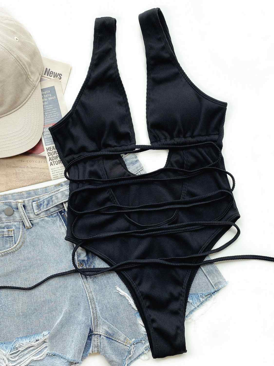 Ribbed lace-up one-piece swimsuit with removable padding and stretchy material.