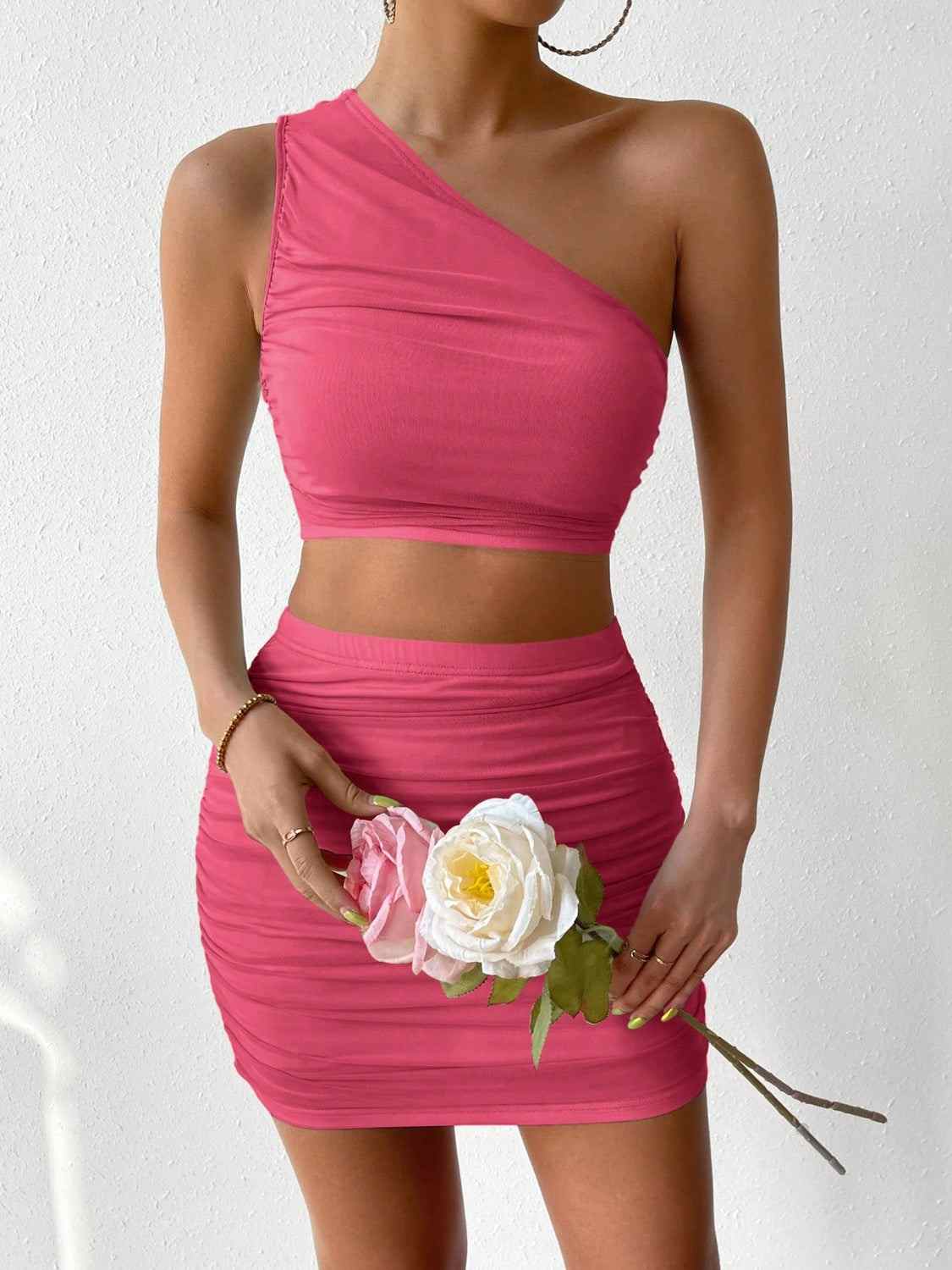Ruched single shoulder top and skirt set, highly stretchy, polyester blend, pink color.