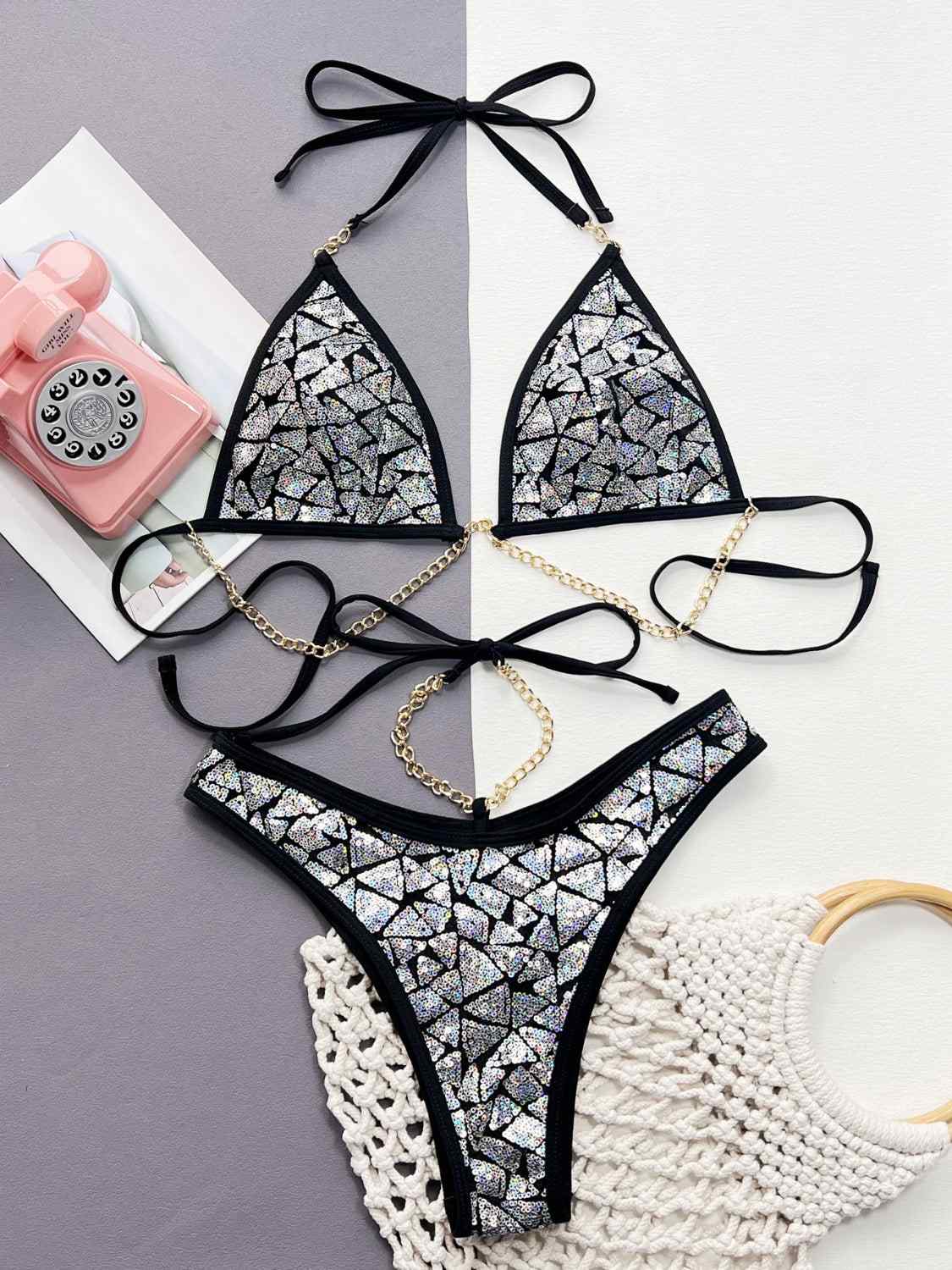 Sequin halter neck two-piece bikini set with removable padding and chain accents.