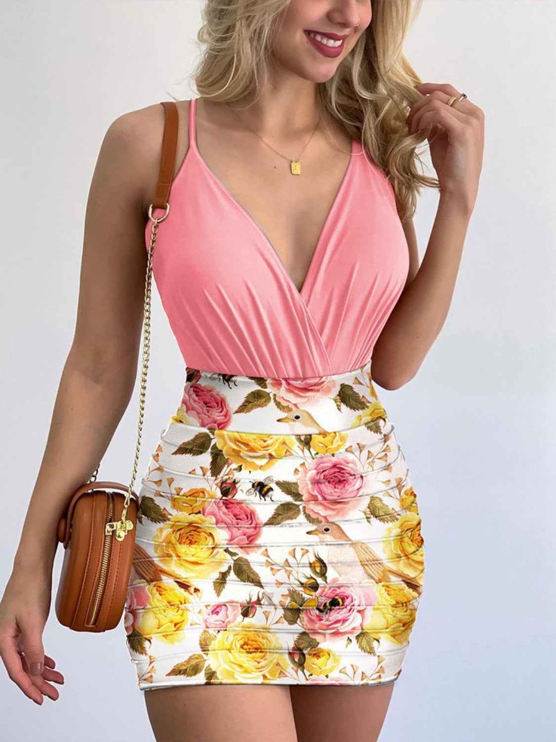 Surplice spaghetti strap top with printed mini skirt set in pink and floral design.