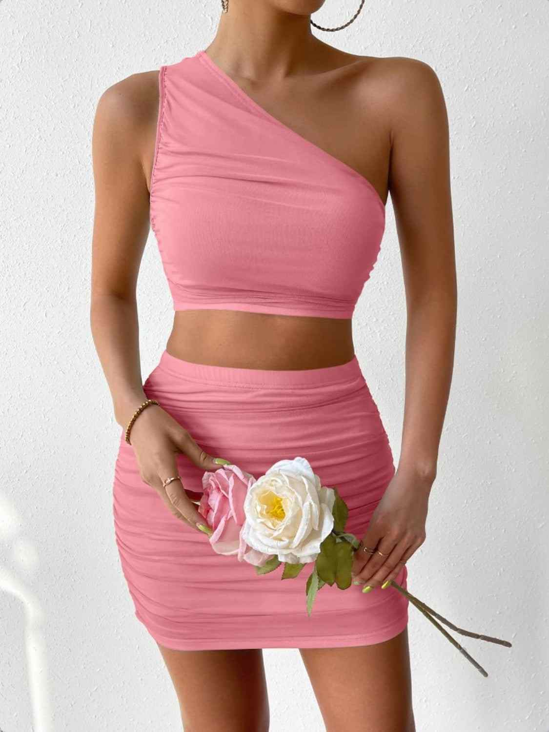 Ruched single shoulder top and skirt set in pink with floral accents.