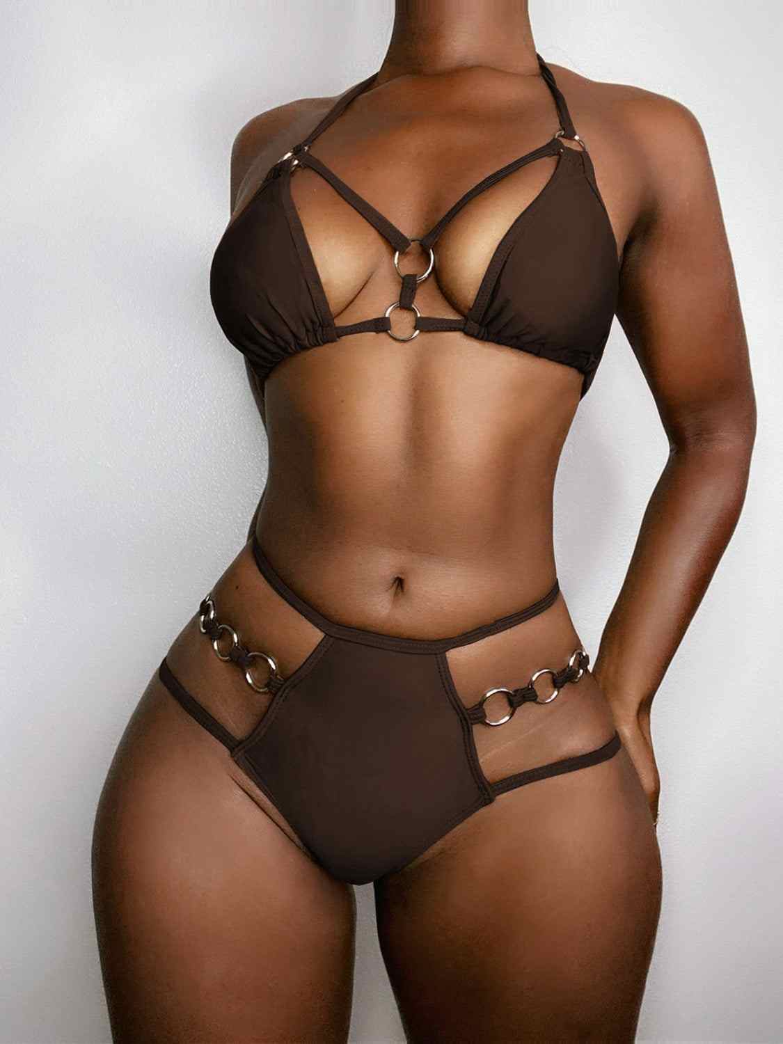 Cutout halter neck two-piece bikini set in dark color with ring accents, removable padding, and no underwire.