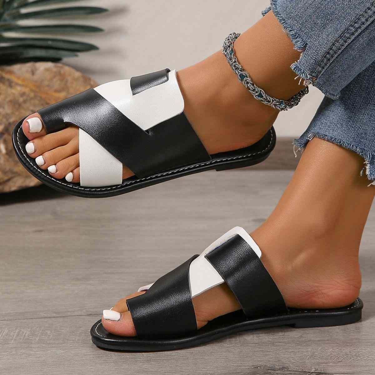 Black and white toe post flat sandals with rubber and artificial PU material.