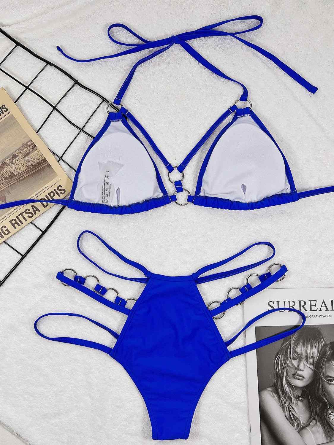 Cutout halter neck two-piece bikini set in blue with decorative straps and removable padding.