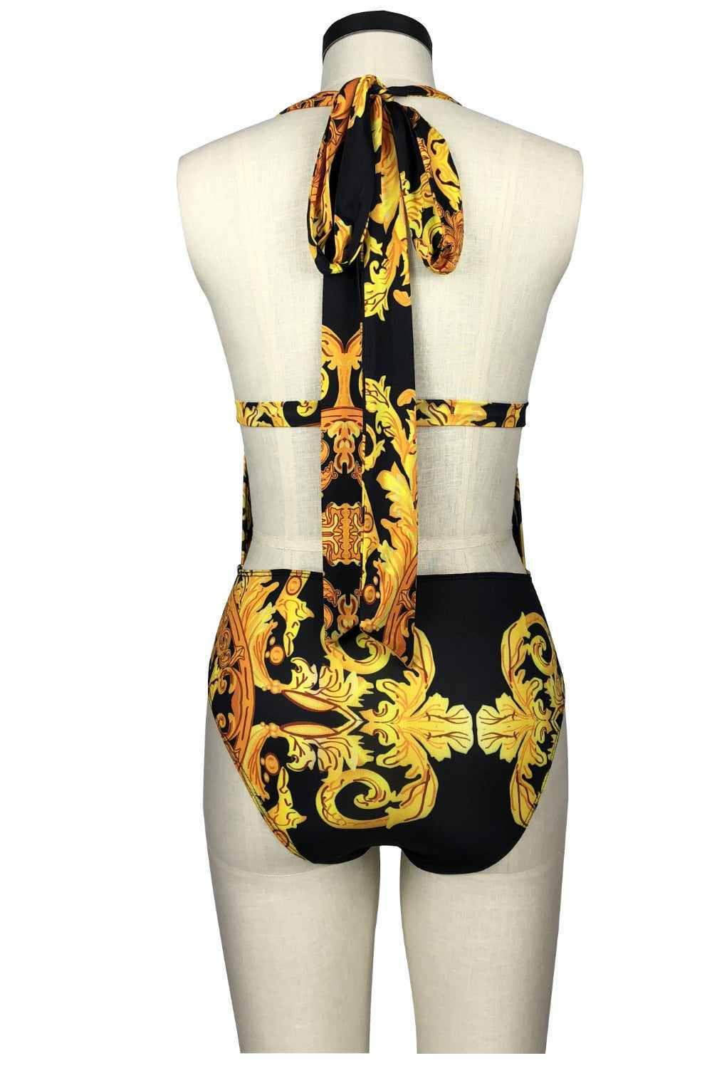 Printed plunge one-piece with cover-up swim set, featuring a gold and black pattern and halter tie detail.
