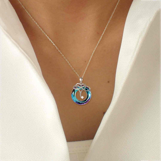 925 sterling silver natural crystal pendant necklace with zircon detailing, worn on a person.
