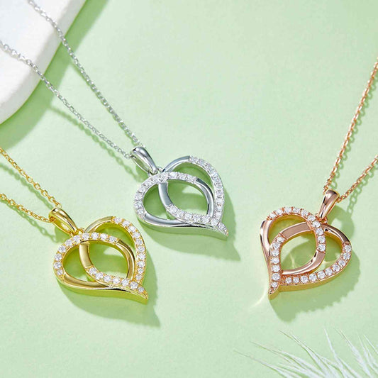 Moissanite 925 sterling silver heart shape necklace in gold, silver, and rose gold-plated designs on a green background.