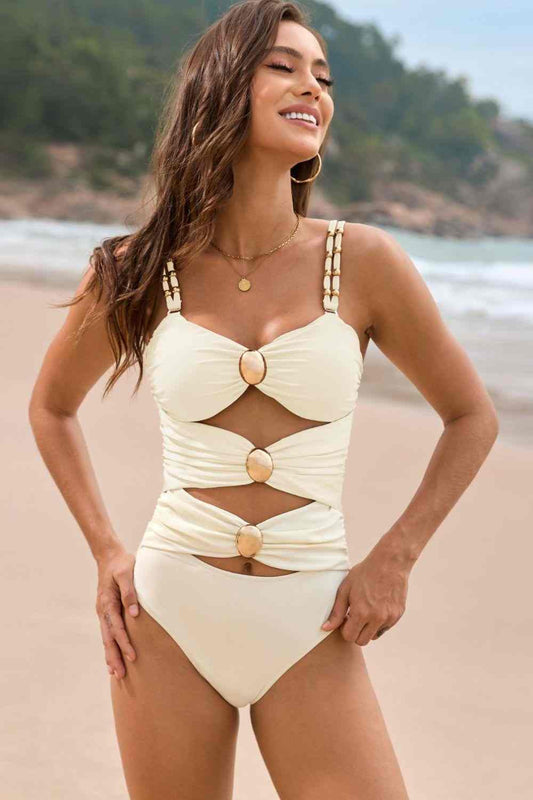 Cutout ruched sweetheart neck one-piece swimwear with removable padding and stretchy material.
