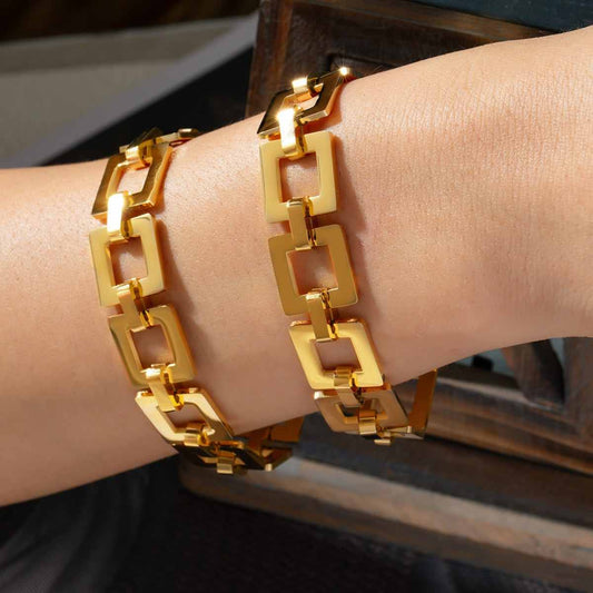 Titanium steel hollow square chain bracelet, 18K gold-plated, displayed on wrist.