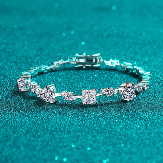 6.2 Carat Moissanite 925 sterling silver bracelet with diverse stone cuts on a shimmering teal background.