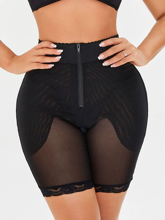 High-waisted lace trim shaping shorts in solid black with zipper, studio style.