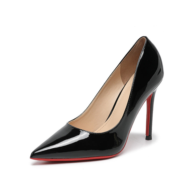 Point toe stiletto pumps in black patent leather with mid heels.