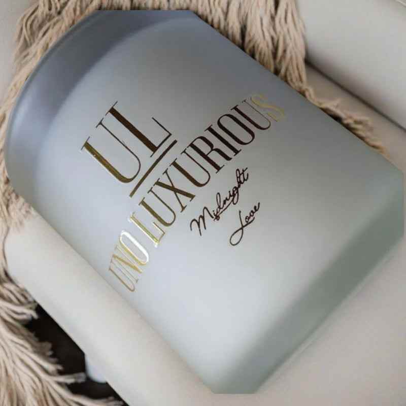 Luxurious Midnight Love Candle with vanilla, orange apple, patchouli, and musk fragrance in elegant packaging.