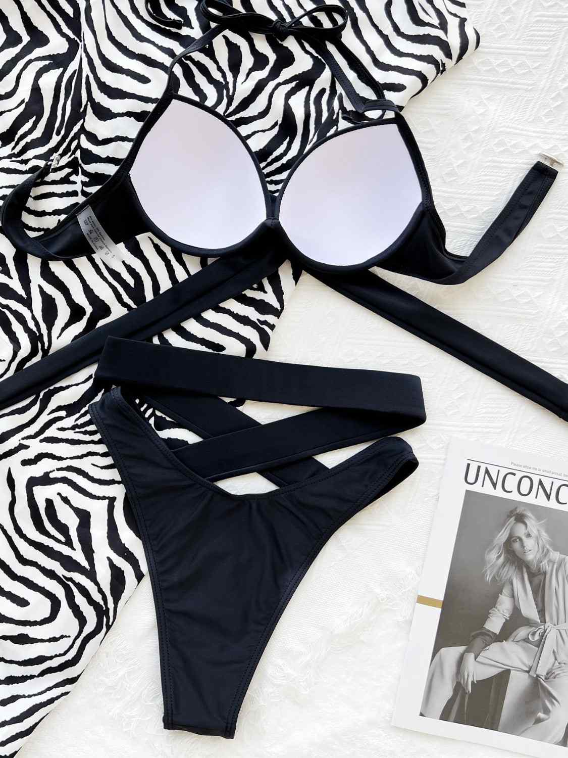 Crisscross halter neck bikini set with ruched design and removable padding.