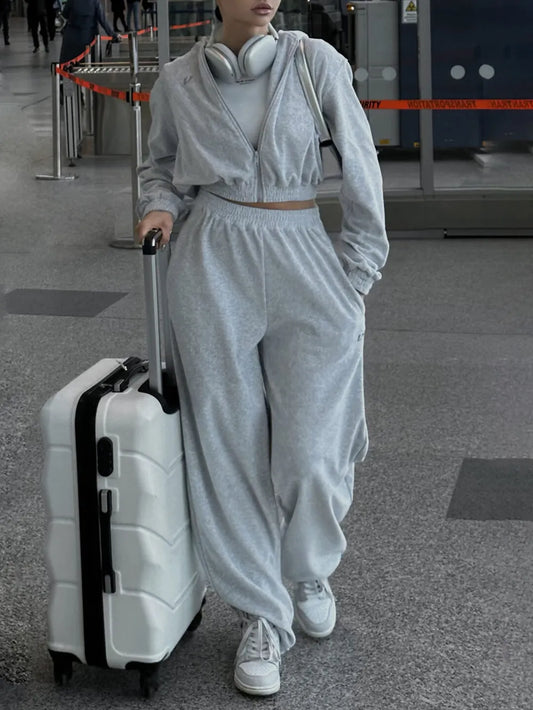 Casual gray zip-up hoodie and pocketed pants set for travel.