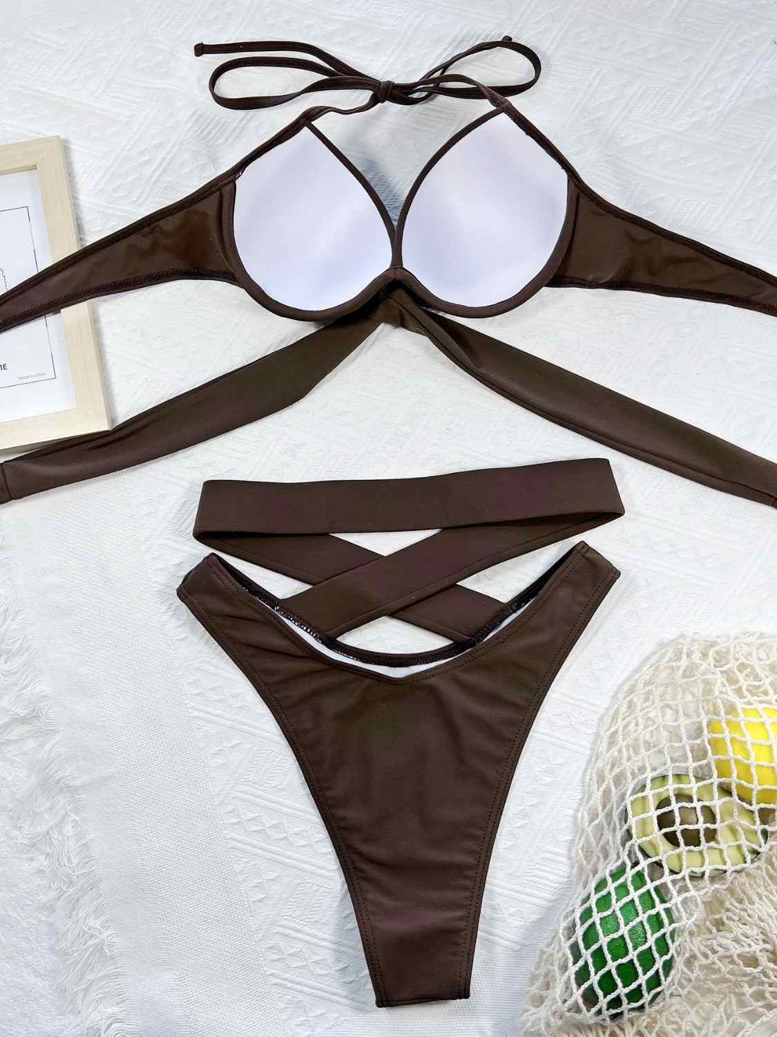 Crisscross halter neck bikini set with ruched design, removable padding, and no underwire.