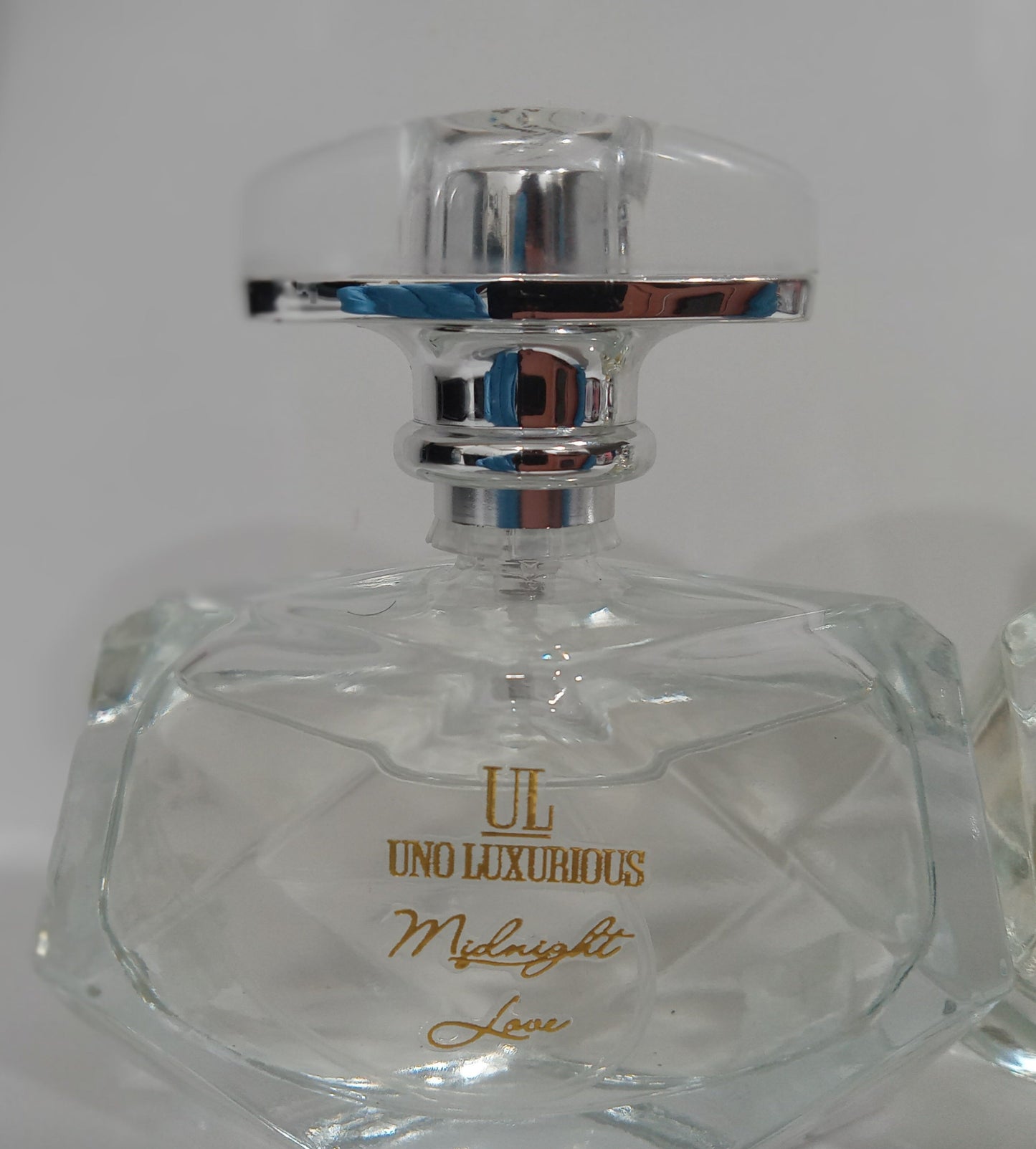 Crystal bottle of "Midnight Love" room spray by Uno Luxurious, an irresistible blend of lemon, orange blossom, vanilla, sandalwood, and musk.