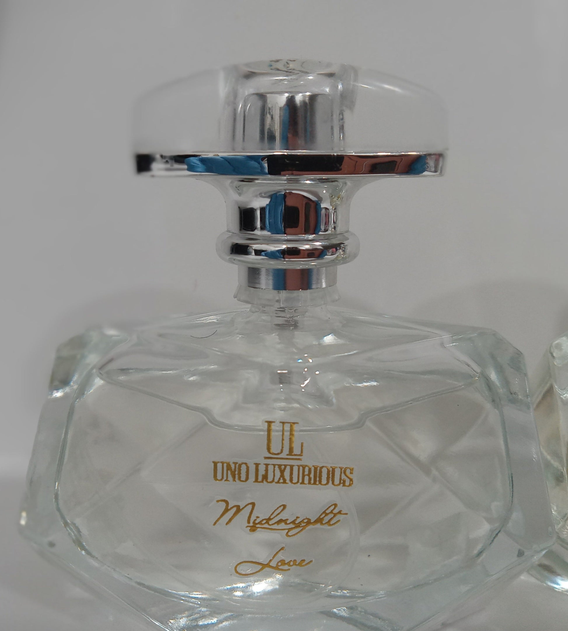 Crystal bottle of "Midnight Love" room spray by Uno Luxurious, an irresistible blend of lemon, orange blossom, vanilla, sandalwood, and musk.
